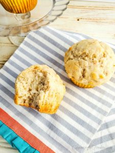 Homemade banana muffins on gray and white stripped cloth napkin