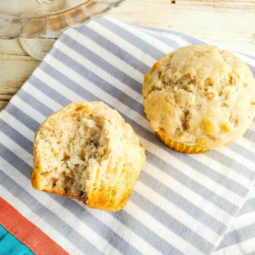 Homemade banana muffins on gray and white stripped cloth napkin