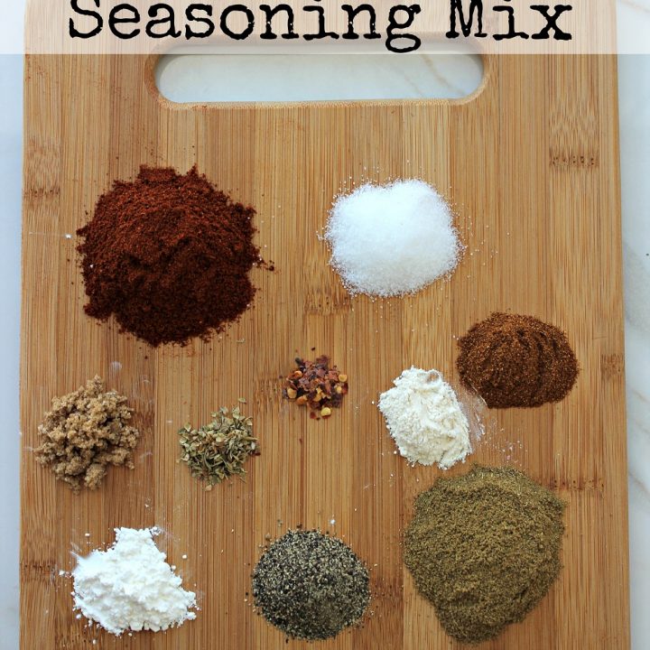 Wood cutting board with little piles of spices needed to make this seasoning. Text overlay at top that says Homemade Taco Seasoning