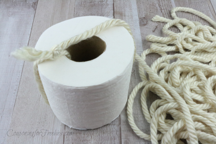 Tie yarn to roll of tp