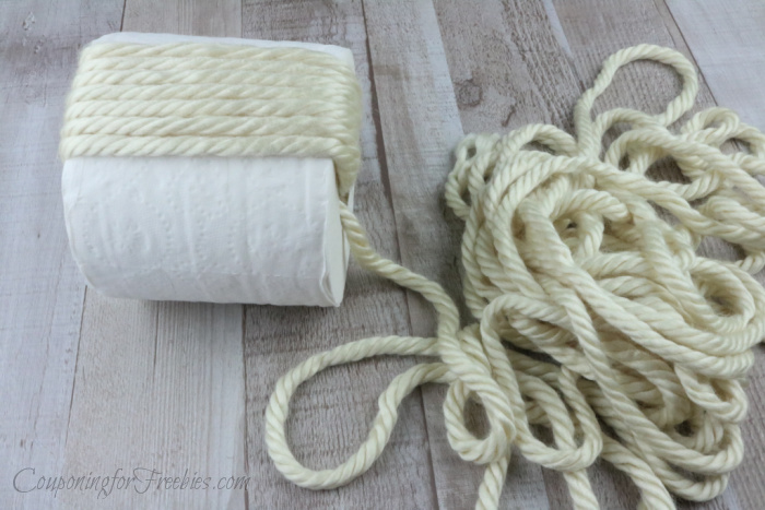 Wrap yarn through and around roll of tp